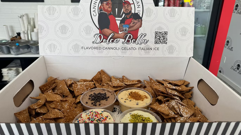 Box of cannoli chips with dips and a branded lid.