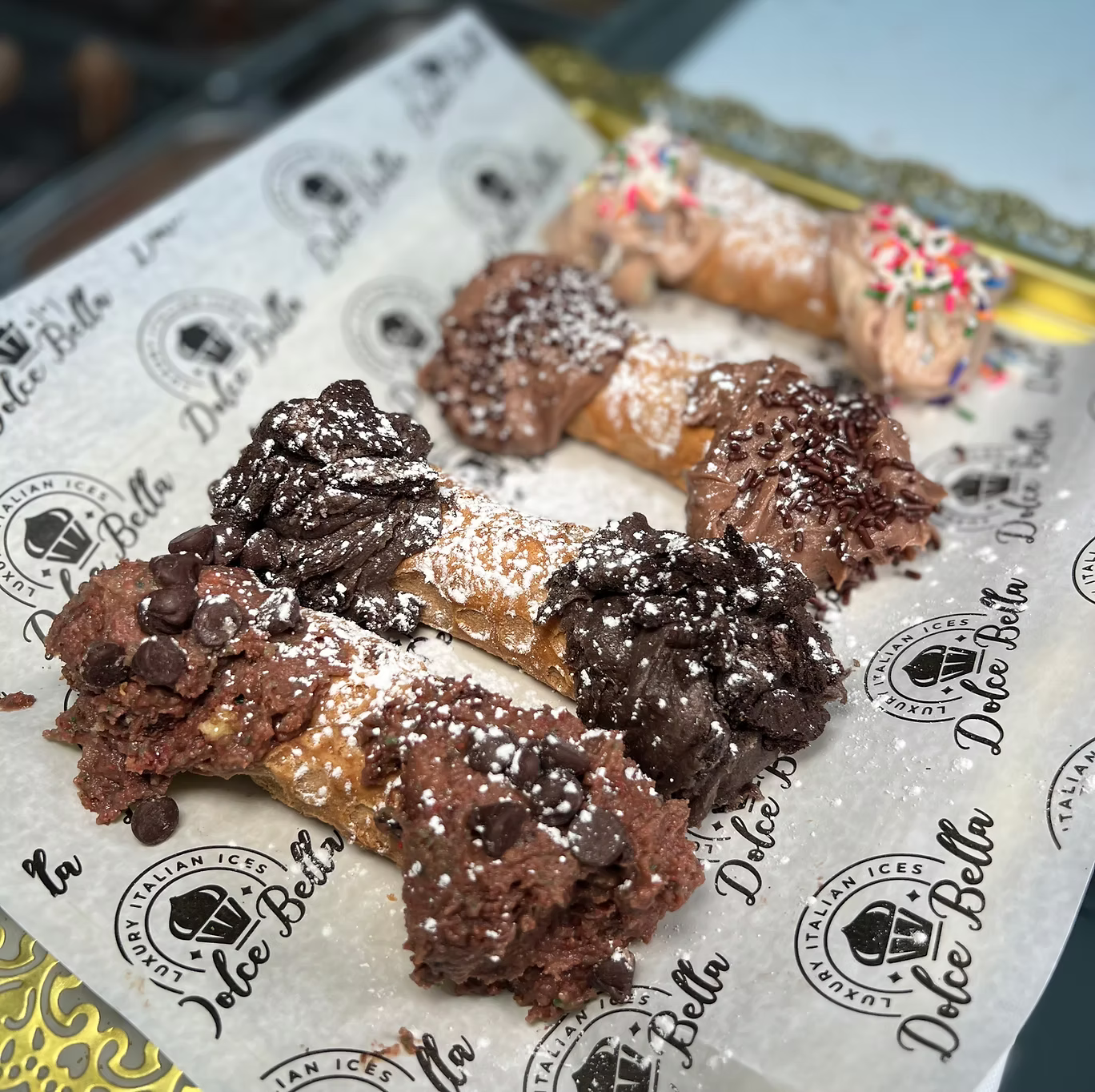 Dolce Bella branded paper with cannoli on a background